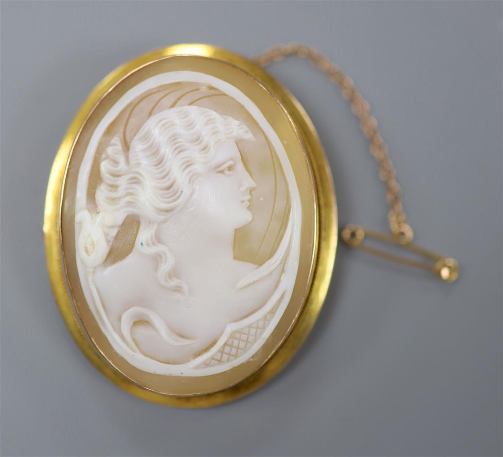 A late Victorian 9ct mounted oval cameo shell brooch, carved with the bust of a lady to sinister, 49mm, gross 12.3 grams.